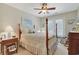 Cozy bedroom featuring a four-poster bed, ceiling fan, and access to the backyard at 112 Birchwood Ln., Conway, SC 29526