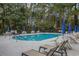 Inviting community pool surrounded by chairs and umbrellas, creating a relaxing oasis for residents at 112 Birchwood Ln., Conway, SC 29526