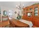 Elegant dining room with a chandelier, wooden furniture, and built-in china cabinet at 112 Birchwood Ln., Conway, SC 29526