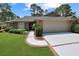 Charming single-story brick home with manicured landscaping and attached two-car garage at 112 Birchwood Ln., Conway, SC 29526