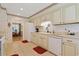 Bright kitchen with white appliances, cream cabinets, and tiled floor at 112 Birchwood Ln., Conway, SC 29526