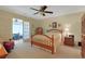 Spacious bedroom with neutral carpet, ceiling fan, and access to a sunroom at 112 Birchwood Ln., Conway, SC 29526