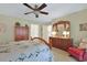 Well-lit bedroom features a ceiling fan, carpet, and wooden furniture at 112 Birchwood Ln., Conway, SC 29526