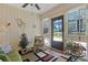 Inviting sun room with pond view, ceiling fan, and comfortable seating at 112 Birchwood Ln., Conway, SC 29526