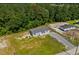 Home with a sprawling yard, a freshly laid driveway, and lush green surrounding trees at 1126 Amanda Lane, Loris, SC 29569