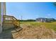 The backyard includes a wooden deck and overlooks a vast and open field at 1126 Amanda Lane, Loris, SC 29569
