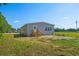 Exterior of home showcases a wooden porch and manicured lawn in a peaceful setting at 1126 Amanda Lane, Loris, SC 29569