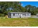 Charming one-story home featuring a welcoming front porch, tidy yard, and blue-gray siding at 1126 Amanda Lane, Loris, SC 29569