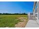 Front porch with steps and white railing offering serene views of the expansive yard at 1126 Amanda Lane, Loris, SC 29569