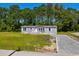 Attractive single-story home with gray siding, white trim, and lush landscaping at 1126 Amanda Lane, Loris, SC 29569