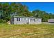 Inviting single-story home with gray siding, white trim and front porch at 1126 Amanda Lane, Loris, SC 29569
