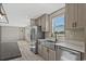 Kitchen boasts stainless appliances, granite countertops, and a farmhouse style sink at 1126 Amanda Lane, Loris, SC 29569