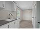 Well-appointed laundry room features cabinetry, sink, modern fixtures, and practical design for efficient chores at 1126 Amanda Lane, Loris, SC 29569