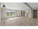 Open concept living room with kitchen access, modern flooring, and plenty of light at 1126 Amanda Lane, Loris, SC 29569