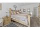 Bedroom with wood look floors, a large bed and a nightstand at 116 Kingsbury Loop # C, Conway, SC 29526