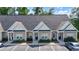 Charming one-story townhome with neutral siding and black trim, surrounded by lush landscaping and convenient parking at 116 Kingsbury Loop # C, Conway, SC 29526