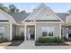 Inviting front entrance of this townhome featuring a black door, manicured landscaping, and tidy walkway at 116 Kingsbury Loop # C, Conway, SC 29526