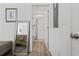 Hallway view of bathroom with wood-look flooring and white doors at 116 Kingsbury Loop # C, Conway, SC 29526
