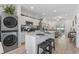 Modern kitchen with stainless steel appliances, granite countertops, and open layout leading to the living area at 116 Kingsbury Loop # C, Conway, SC 29526
