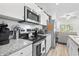 Stylish kitchen featuring stainless steel appliances, granite countertops, and white cabinetry at 116 Kingsbury Loop # C, Conway, SC 29526