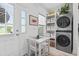 Cozy breakfast nook with a view, featuring a modern washer/dryer combo and stylish shelving at 116 Kingsbury Loop # C, Conway, SC 29526