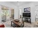 Bright living room leading to a screened porch, complete with a modern television at 116 Kingsbury Loop # C, Conway, SC 29526