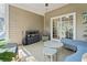 Cozy screened-in patio features comfortable seating and a small table at 116 Kingsbury Loop # C, Conway, SC 29526
