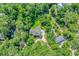 Aerial view of a secluded home surrounded by lush trees, featuring a long driveway and mature landscaping at 1176 Old Plantation Dr., Pawleys Island, SC 29585