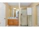 Bright bathroom featuring a glass door shower, oak cabinets, and ample counter space at 1176 Old Plantation Dr., Pawleys Island, SC 29585