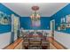 Elegant dining room featuring blue walls, a chandelier, and seating for eight at 1176 Old Plantation Dr., Pawleys Island, SC 29585