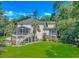 Beautiful two-story home featuring a screened porch, a spacious yard and great natural lighting at 1176 Old Plantation Dr., Pawleys Island, SC 29585