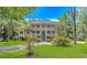 Gorgeous two-story home with a double front porch, classic shutters, and lush landscaping at 1176 Old Plantation Dr., Pawleys Island, SC 29585