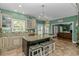 Bright kitchen with a center island, granite countertops, and an open layout to the living room at 1176 Old Plantation Dr., Pawleys Island, SC 29585