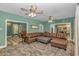 Spacious living room featuring a large sectional, decorative rug, and multiple ceiling fans at 1176 Old Plantation Dr., Pawleys Island, SC 29585