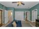 Spacious living room with a blue couch, ceiling fan, storage closet and easy access to other rooms at 1176 Old Plantation Dr., Pawleys Island, SC 29585