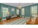 Cozy living room with hardwood floors, a decorative rug, a chandelier, and natural light from large windows at 1176 Old Plantation Dr., Pawleys Island, SC 29585