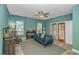 Comfortable living room featuring tiled floor, a couch, ceiling fan and access to the outside at 1176 Old Plantation Dr., Pawleys Island, SC 29585