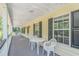 Inviting front porch with a table and chairs, perfect for enjoying the outdoors at 1176 Old Plantation Dr., Pawleys Island, SC 29585
