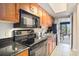 Well-equipped kitchen featuring modern appliances and granite countertops at 1200 N Ocean Blvd. # 211, Myrtle Beach, SC 29577