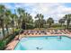 Resort-style pool area surrounded by lush landscaping and lounge chairs for ultimate relaxation at 1200 N Ocean Blvd. # 211, Myrtle Beach, SC 29577