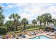Beautiful pool area offers ocean views, palm trees, sun loungers, and a Tropical Paradise bar at 1200 N Ocean Blvd. # 211, Myrtle Beach, SC 29577