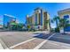 Street view of Holiday Pavilion Resort with palm trees, an advertisement sign and a brick road at 1200 N Ocean Blvd. # 211, Myrtle Beach, SC 29577