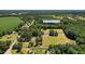 Aerial view highlighting the large lot, part fields, part wooded, and a single-Gathering home at 1206 French Rd, Mullins, SC 29574