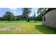 Expansive backyard with a brick wall and view of lush fields beyond at 1206 French Rd, Mullins, SC 29574