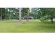 Serene property nestled among mature trees, featuring a classic brick home and expansive yard at 1206 French Rd, Mullins, SC 29574