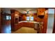 Well-lit kitchen featuring wood cabinets, white countertops, and views to the rest of the house at 1206 French Rd, Mullins, SC 29574