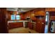 Bright kitchen with wooden cabinets, open shelving and a view of the back yard at 1206 French Rd, Mullins, SC 29574