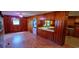 Living room with wood paneling, and a view of the open kitchen and front door at 1206 French Rd, Mullins, SC 29574