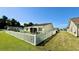 Backyard featuring a white picket fence, well-maintained lawn, and a screened in patio at 1300 Ruddy Ct., Conway, SC 29527