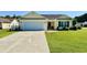 Charming single-story home featuring a two-car garage and a lush front yard at 1300 Ruddy Ct., Conway, SC 29527